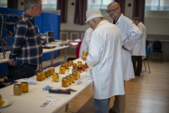 National Honey Judge Mike Duffin (centre) discusses entries with stewards Larry Phipps (L - Melksham BKA) and John Barber (R - Kennet BKA)  at the Wiltshire Bee & Honey Day 2019