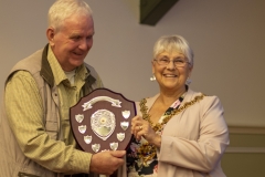 Frank Lenert accepts the Kennet Perpetual Trophy on behalf of Geraldine Lenert (West Wilts BKA) from Mayor Judy Rose, for the best non-honey entry in the show at the Wiltshire Bee & Honey Day 2019